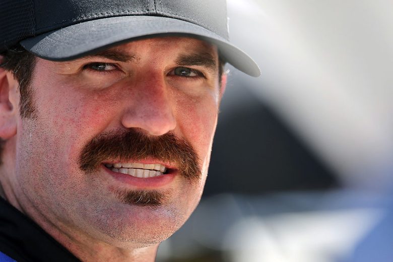 Corey LaJoie looks on.