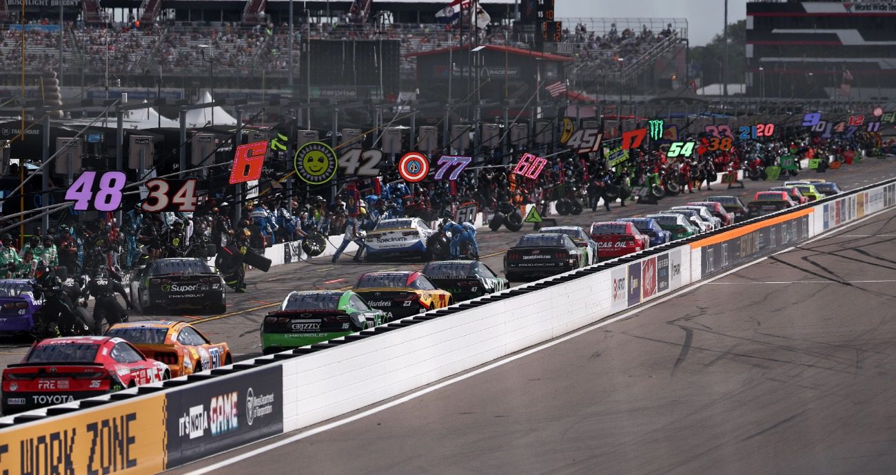 View of Cup Series cars driving down pit road at World Wide Technology Raceway at Gateway.