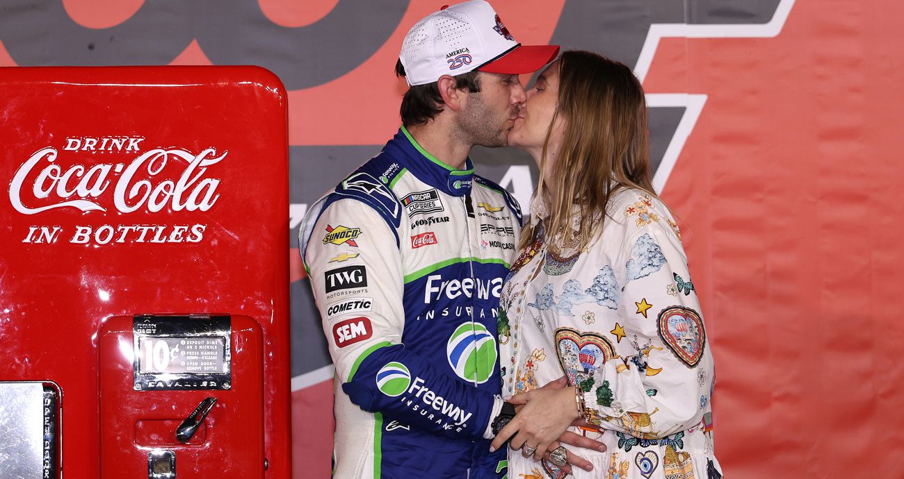 Daniel Suárez (L) and Julia Piquet (R) kiss in Victory Lane at Charlotte Motor Speedway.