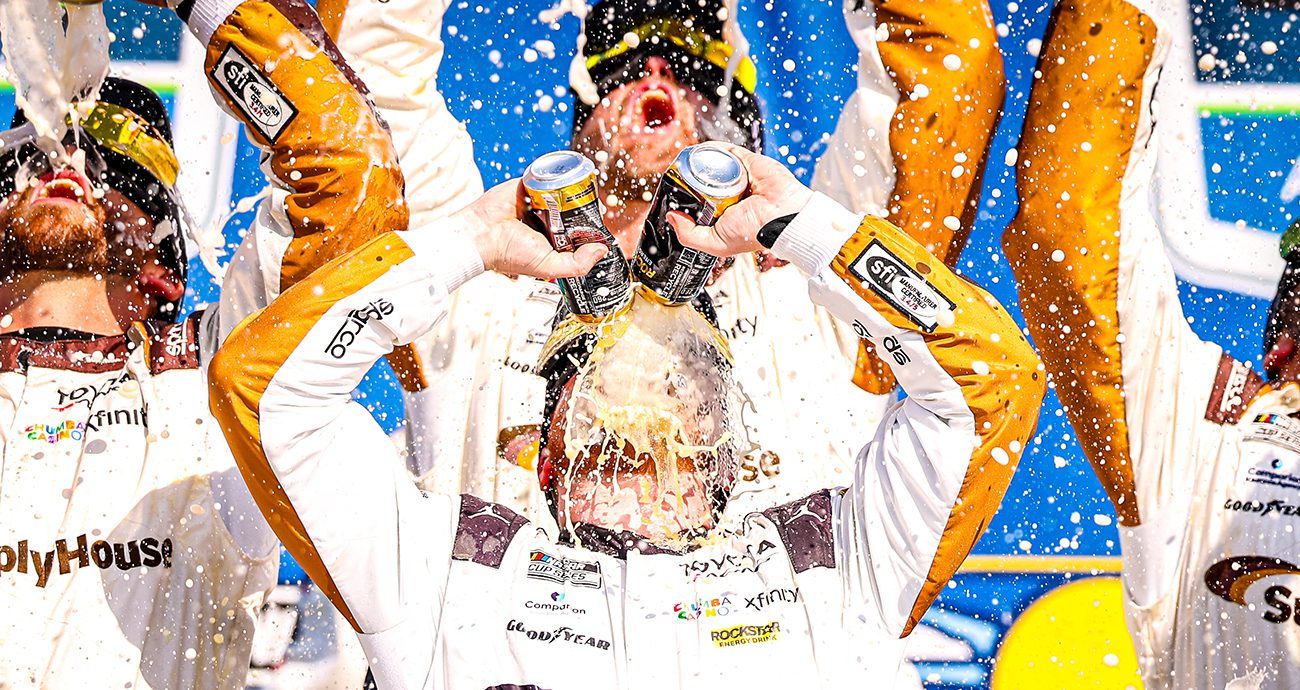 tyler reddick celebrates in victory lane at kansas