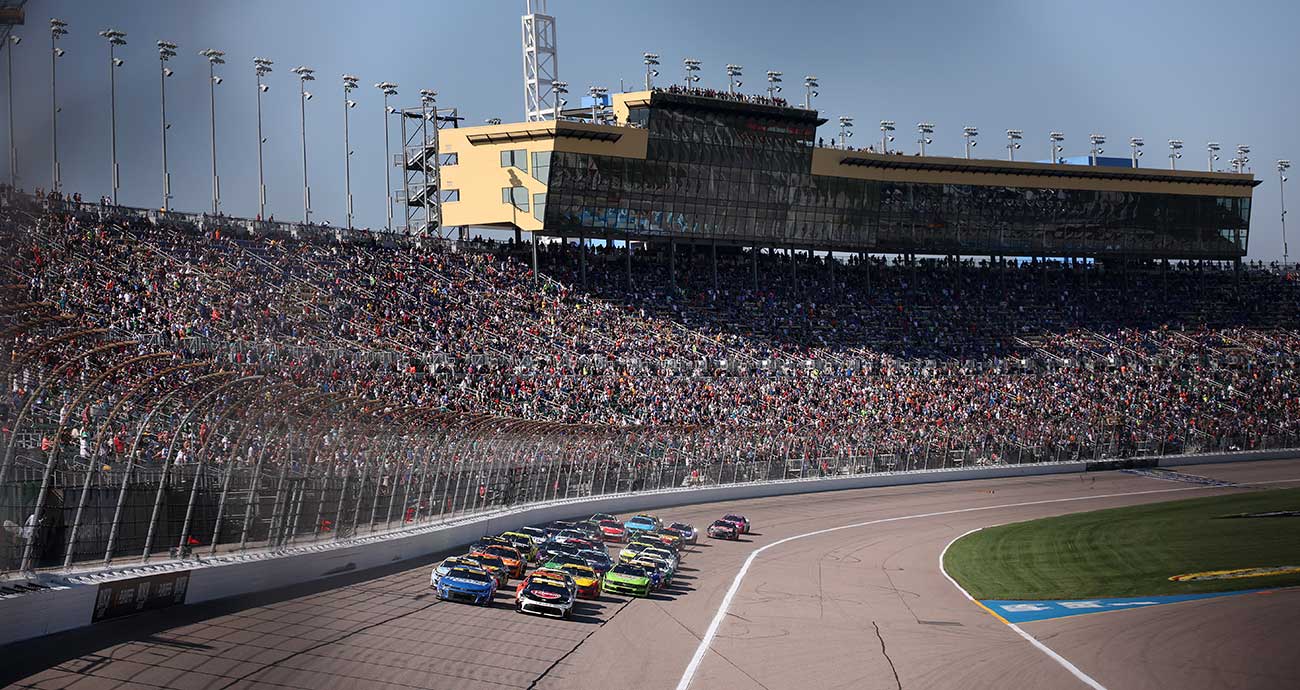 The Cup Series fields barrels toward Turn 1 during last year's playoff race at Kansas Speedway