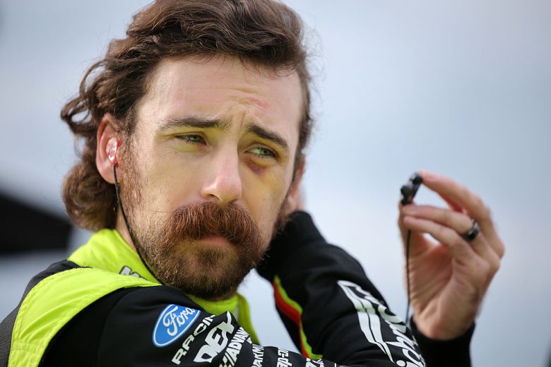 Ryan Blaney looks on.