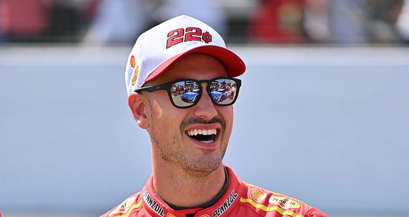 Joey Logano looks on.