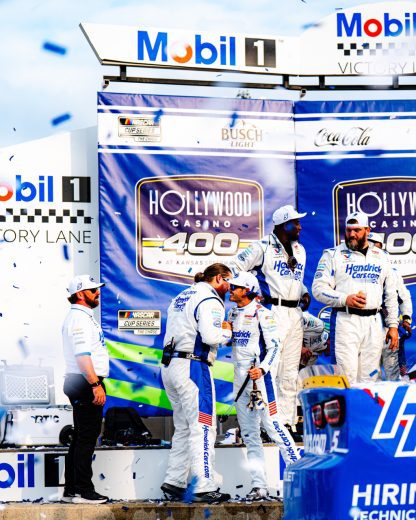 Kyle Larson greets his crew members in Victory Lane at Kansas Speedway.