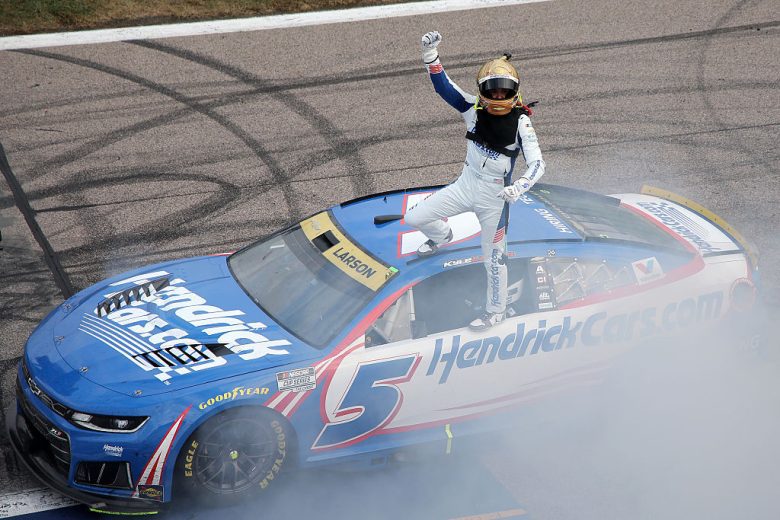 Kyle Larson stands atop his No. 5 Hendrick Motorsports Chevrolet at Kansas Speedway.