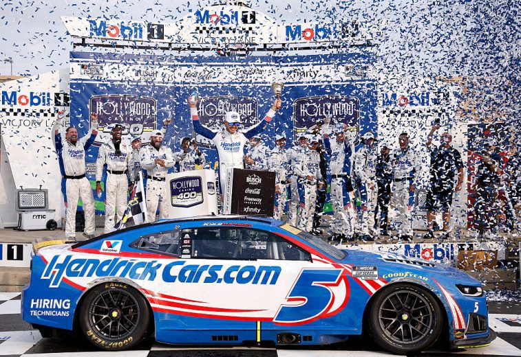 Kyle Larson celebrates in Victory Lane at Kansas Speedway.