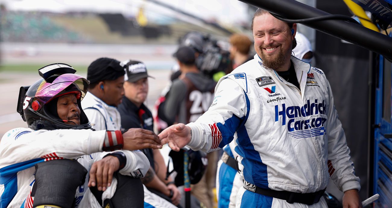 Members of Kyle Larson's pit crew celebrate during a NASCAR Cup Series race at Kansas.