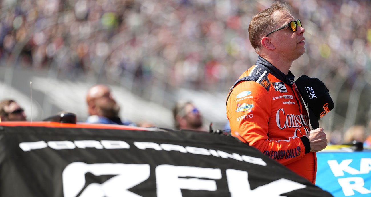 Brad Keselowski looks on next to his RFK Racing Ford in the NASCAR Cup Series.