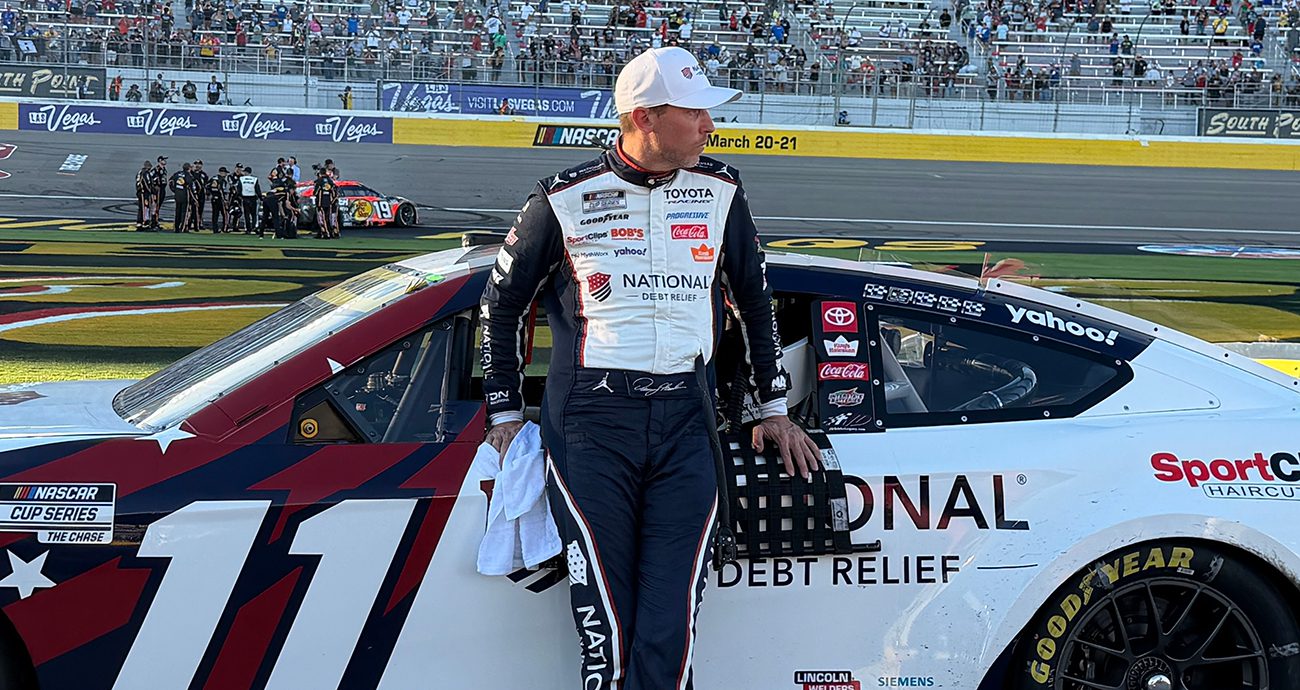 Denny Hamlin stands on pit road at Las Vegas Motor Speedway.