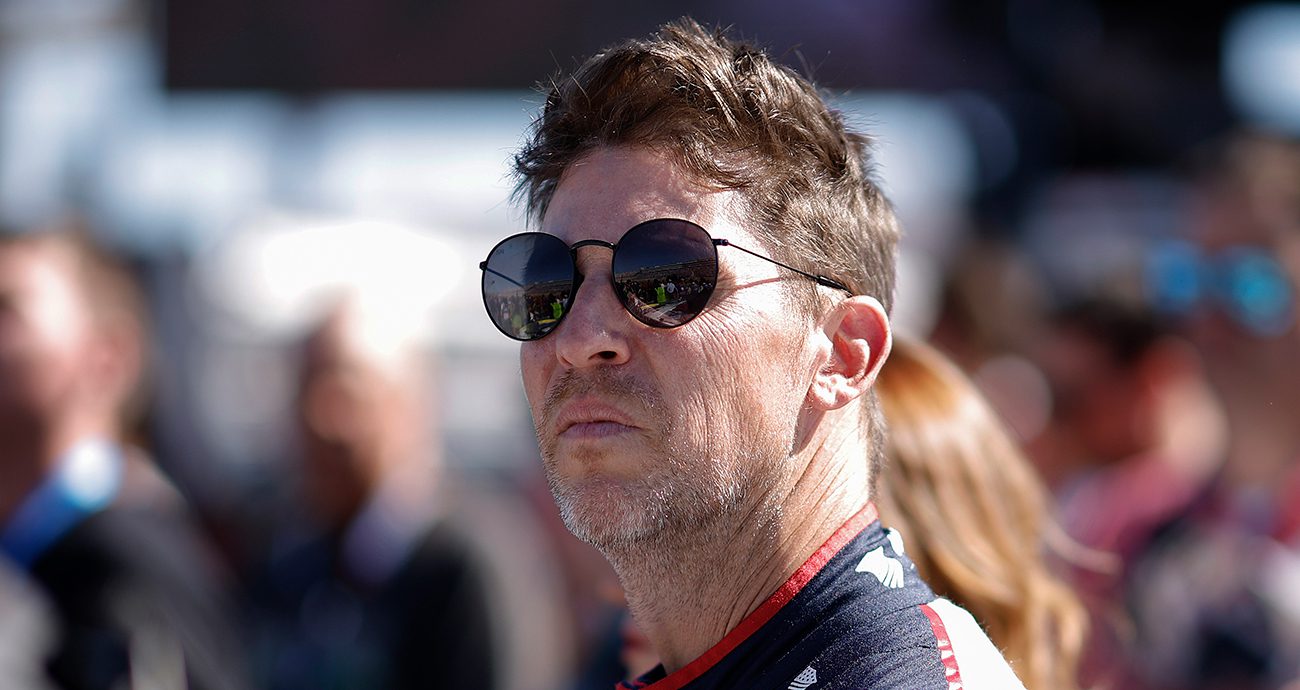Denny Hamlin looks on.