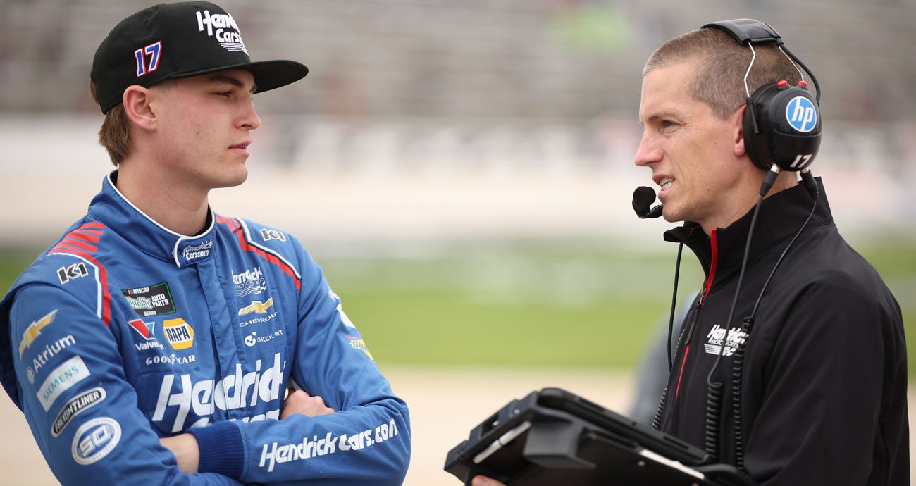 Corey Day (L) and Adam Wall (R) talk at Texas Motor Speedway.