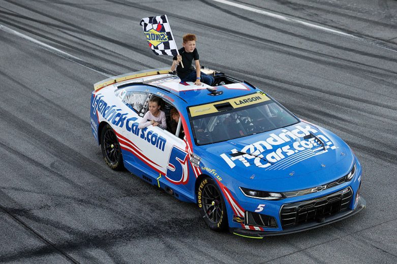 Owen Larson waves the checkered flag.
