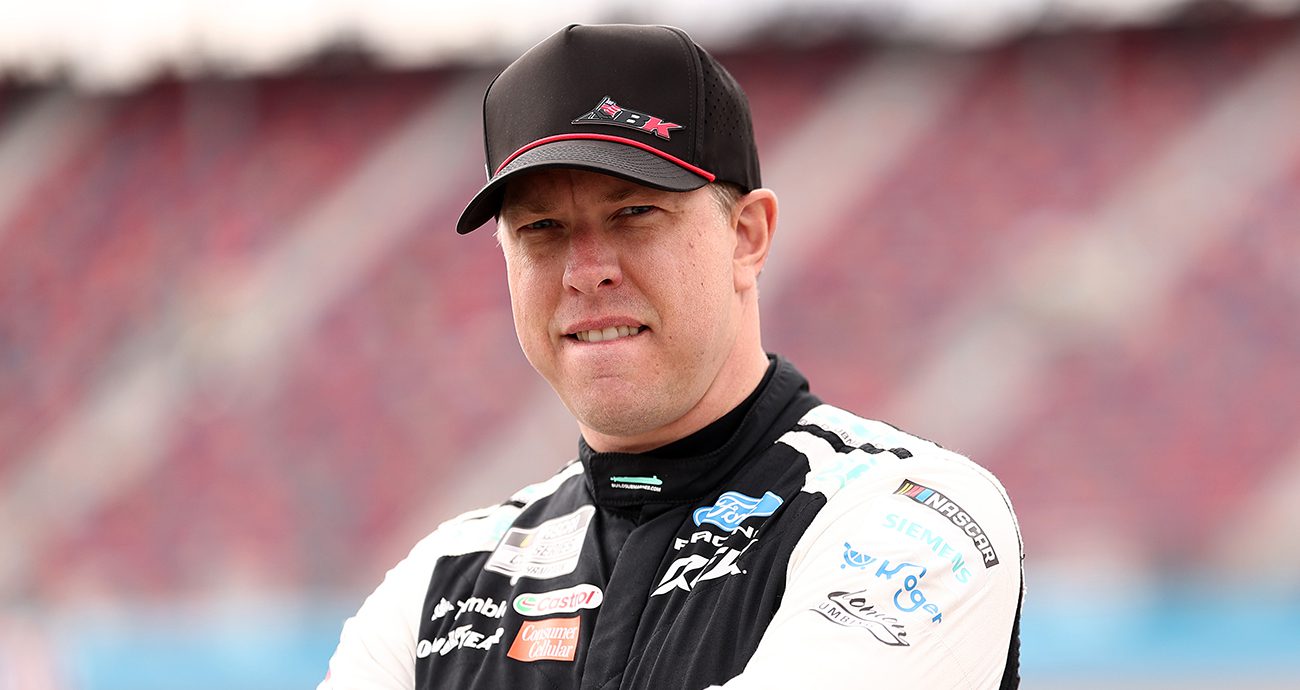 Brad Keselowski stands at Phoenix Raceway.